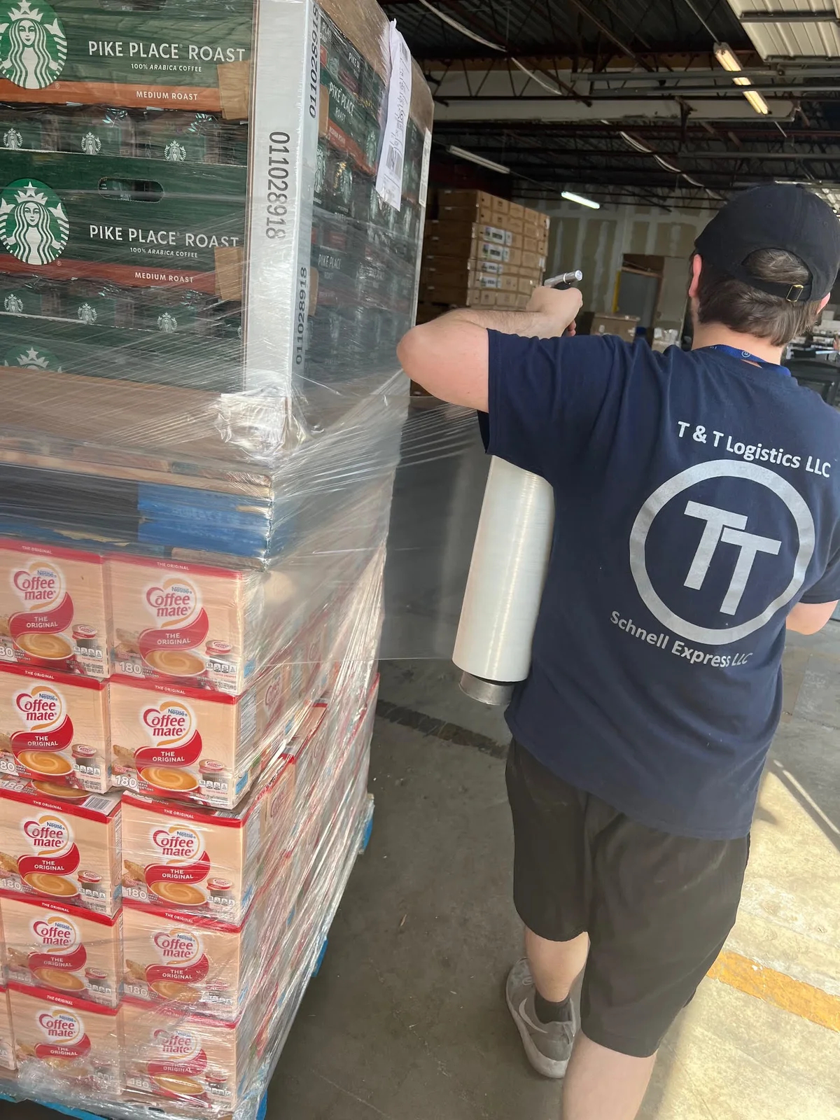 A T&T team member wrapping a pallet of freight in the warehouse